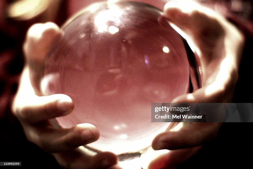 Hands holding crystal ball