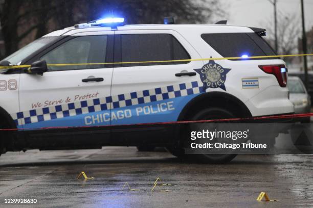 Bullet casings litter the street as police investigate the scene of a shooting on West Congress Parkway in Chicago, Tuesday, Feb. 22, 2022.