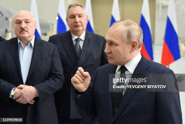 Russian President Vladimir Putin speaks as Belarus President Alexander Lukashenko and Roscosmos chief Dmitry Rogozin listen on, during his visit to...