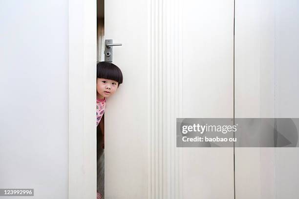 heading out of little boy from white door - kid peeking stock pictures, royalty-free photos & images