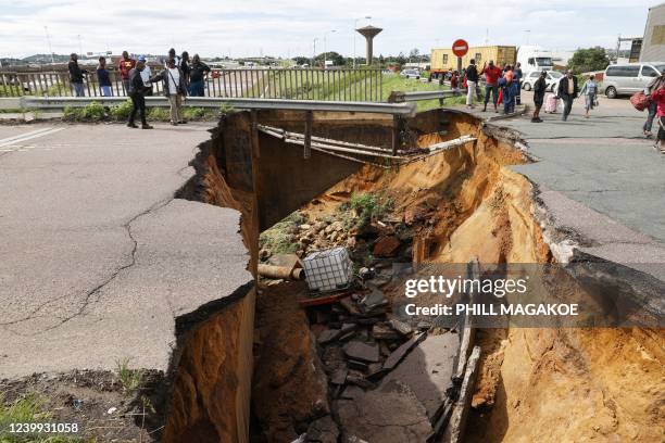 General view of a crack in the road following heavy rains and winds in Durban, on April 12, 2022. - At least five people have been killed in floods...