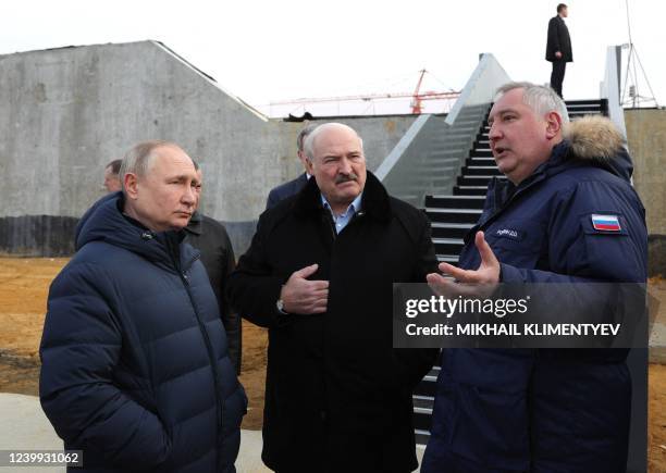 Roscosmos chief Dmitry Rogozin gives explanations to Russia's President Vladimir Putin and Belarus President Alexander Lukashenko during their visit...