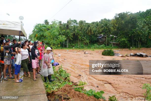 Residents wait for news of relatives after a mountain side collapsed in the village of Bunga, Baybay town, Leyte province, in southern Philippines on...