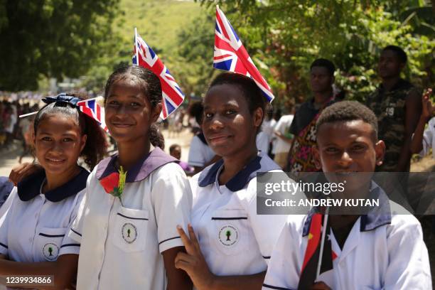 School children watch Britain's Princess Anne attending an event in Port Moresby on April 12 during her royal trip to Papua New Guinea in celebration...