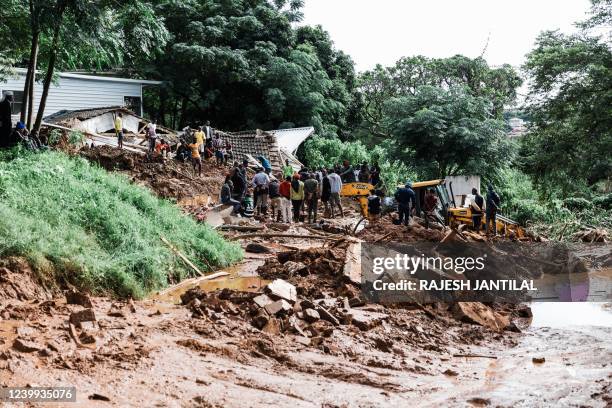 People dig for a Muslim worshipper believed to be trapped after a local mosque collapsed following heavy rains and winds in Durban, on April 12,...