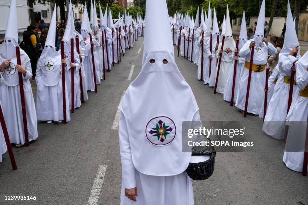 Penitents march during a procession as they celebrate Holy Monday. After two years of Covid-19 travel restrictions and cancellations in Spain, they...