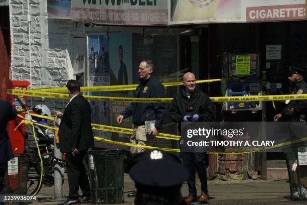 Members of the New York Police Department and emergency personel crowd the streets near a subway station in New York City on April 12 after at least...