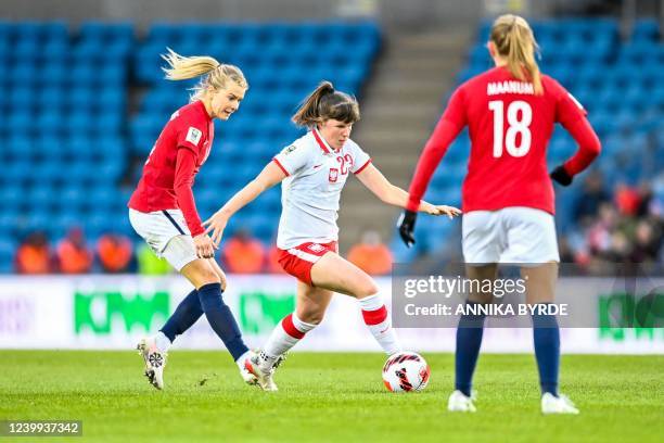 Norway's forward Ada Hegerberg and Poland's Polish Adriana Achcinska vie for the ball during the Women's FIFA World Cup 2023 qualification football...