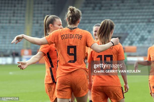 Netherlands' Kayleigh van Dooren, Vivianne Miedema, and Marisa Olislagers react during a friendly football match between the Netherlands and South...