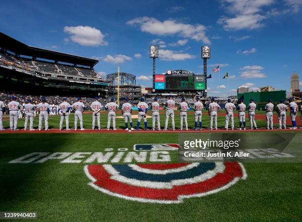 The Chicago Cubs stand during the National Anthem during opening day against the Pittsburgh Pirates at PNC Park on April 12, 2022 in Pittsburgh,...