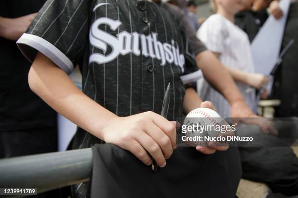 Fan holds a ball with the Chicago White Sox logo prior to the game between the Seattle Mariners and the Chicago White Sox at Guaranteed Rate Field on...