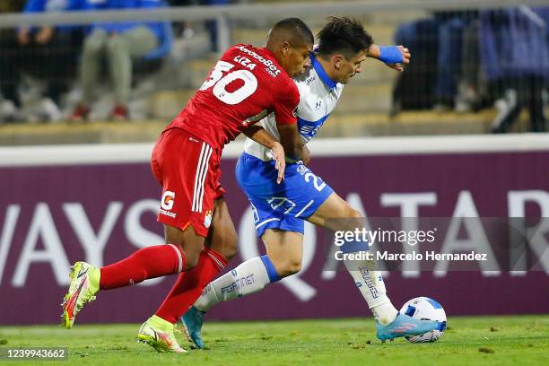 Alfonso Parot of Universidad Catolica fights for the ball with Carlos Liza of Sporting Cristal during a match between Universidad Catolica and...