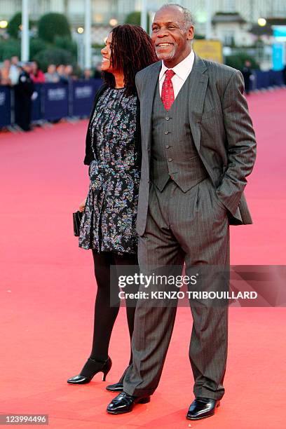 Actor Danny Glover and his wife Asake Bomani hit the red carpet before a homage ceremony during the 37th US Film Festival, in Deauville, northwestern...