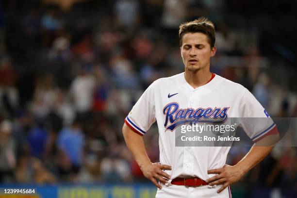 Corey Seager of the Texas Rangers looks down after flying out to deep centerfield against the Colorado Rockies during the fifth inning at Globe Life...