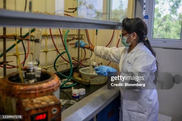 An employee works under a fume hood in a laboratory at a Laurus Labs Ltd. Research and development center in Genome Valley in Hyderabad, India, on...