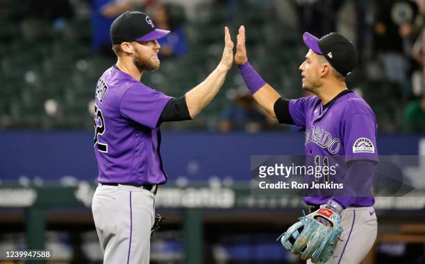 Daniel Bard and Jose Iglesias of the Colorado Rockies celebrate a 4-1 win over the Texas Rangers at Globe Life Field on April 12, 2022 in Arlington,...