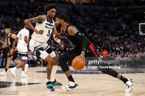 Paul George of the Los Angeles Clippers drives to the basket while Jaden McDaniels of the Minnesota Timberwolves defends in the fourth quarter during...