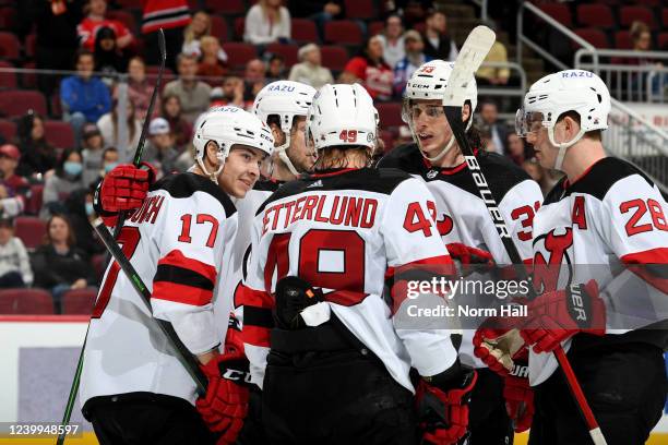 Yegor Sharangovich of the New Jersey Devils celebrates with Fabian Zetterlund, Damon Severson Ryan Graves and Nico Hischier after scoring a goal...