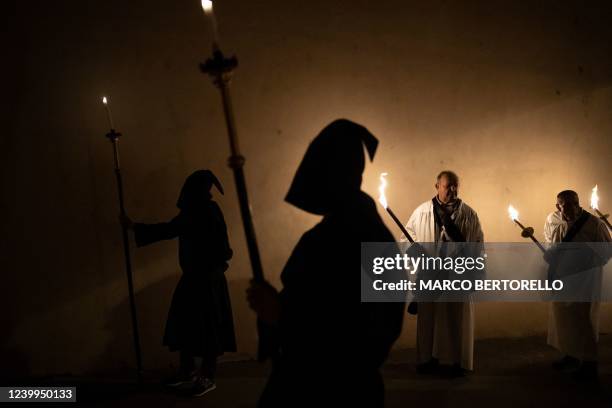 People take part in the traditional popular and baroque funeral Easter rite known as the "Mortorio Pasquale" procession, on April 12, 2022 in...