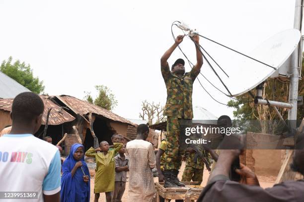 Security officer fixes a mobile network antenna that was diconnected in the Kukawa Village in the Kanam Local Government Area of the Plateau state on...