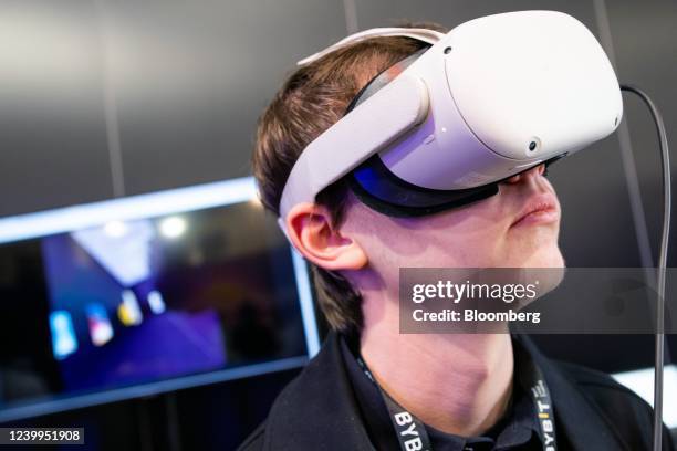 An attendee uses a virtual reality headset at the Paris NFT Day conference in Paris, France, on Tuesday, April 12, 2022. Paris NFT Day is part of the...