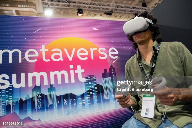 An attendee uses a virtual reality headset at the Metaverse Summit booth at the Paris NFT Day conference in Paris, France, on Tuesday, April 12,...