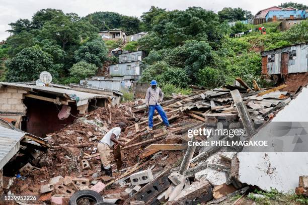 Residents salvage the remains of what use to be the United Methodist Church of South Africa in Clermont, near Durban, on April 13 following heavy...