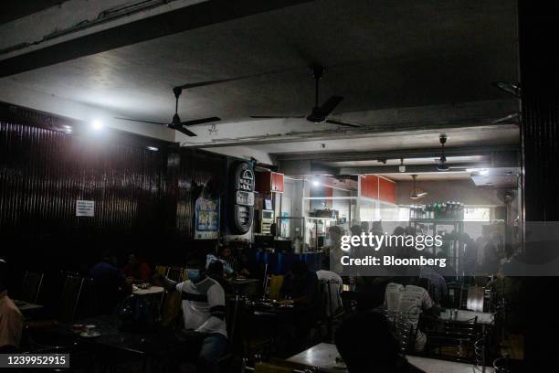 Customers in a restaurant during a power cut in Colombo, Sri Lanka, on Tuesday, April 12, 2022. Sri Lanka warned of an unprecedented default and...