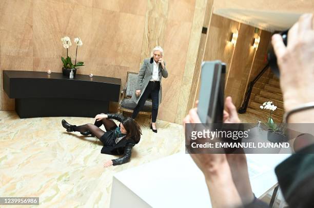 Protester reacts, next to Marie-Caroline Le Pen, after being removed after she entered the venue where French far-right Rassemblement National party...