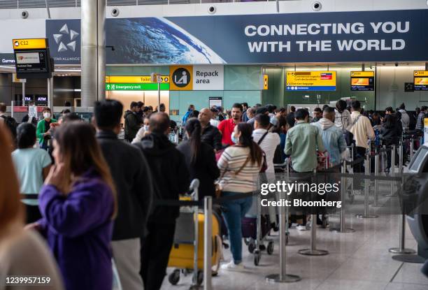 Passengers queue to check in inside the arrivals hall of Terminal 2 at London Heathrow Airport in London, U.K., on Wednesday, April 13, 2022. Travel...