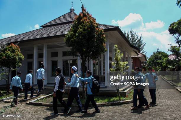 Visually impaired students walk towards the Mosque at the Social Service Center at Griya Harapan Difabel, Dinsos Jabar. This short course in Islamic...
