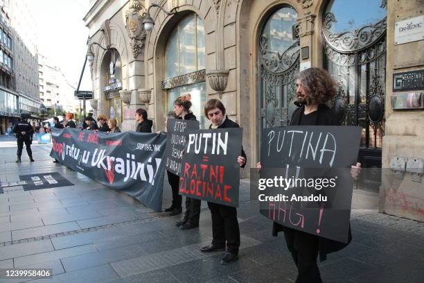 Members of an NGO, "Women in Black", holding banners and flags, gather to hold a solidarity protest against Russia's attacks on Ukraine in Belgrade,...