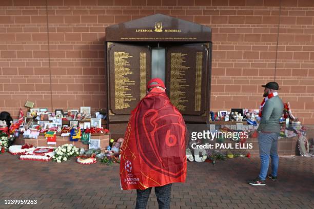 Liverpool's supporters gather in front the eternal flame of the Hillsborough memorial as they arrive to attend the UEFA Champions League quarter...