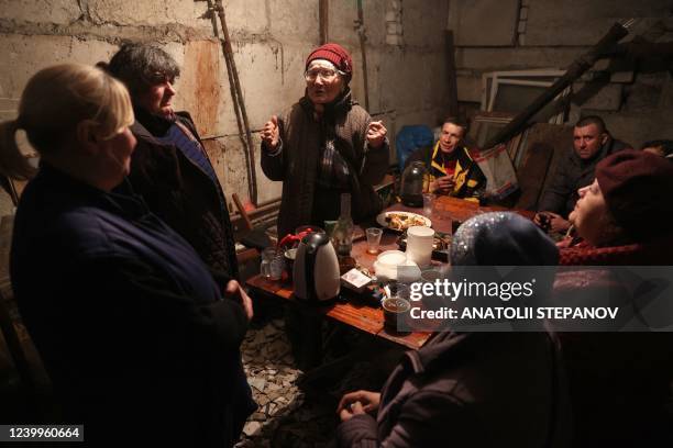 Local residents celebrate a birthday in the basement of a residential building to protect themselves from shelling in Lysychansk in the Luhansk...