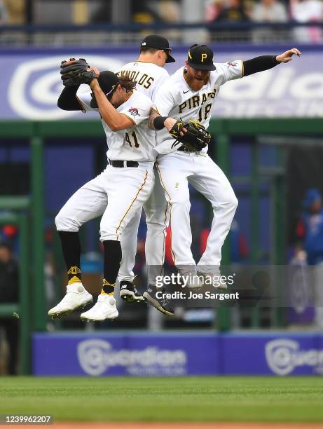 Jake Marisnick, Bryan Reynolds and Ben Gamel of the Pittsburgh Pirates celebrate after a 6-2 win over the Chicago Cubs at PNC Park on April 13, 2022...