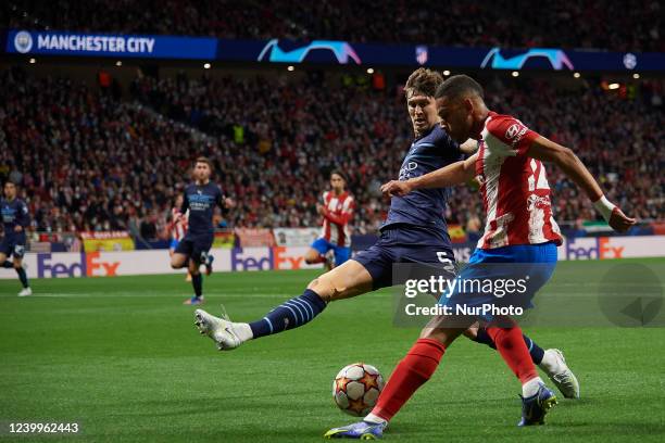 Renan Lodi of Atletico Madrid does passed front John Stones of Manchester City during the UEFA Champions League Quarter Final Leg Two match between...