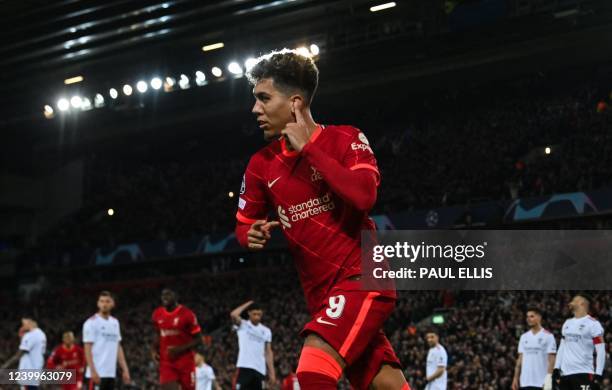 Liverpool's Brazilian midfielder Roberto Firmino celebrates after scoring his team third goal during the UEFA Champions League quarter final second...