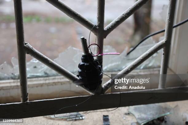Hand grenade is seen tied to window's guard of a house in the Ukrainian city of Mariupol under the control of Russian military and pro-Russian...
