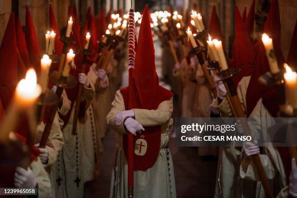 Penitents members of the "Real Hermandad del Santisimo Cristo de las Injurias" parade during the "Silence" procession during Holy Week in the...