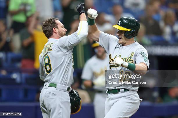 Jed Lowrie of the Oakland Athletics congratulates Sean Murphy on his three-run home run against the Tampa Bay Rays in the third inning of a baseball...