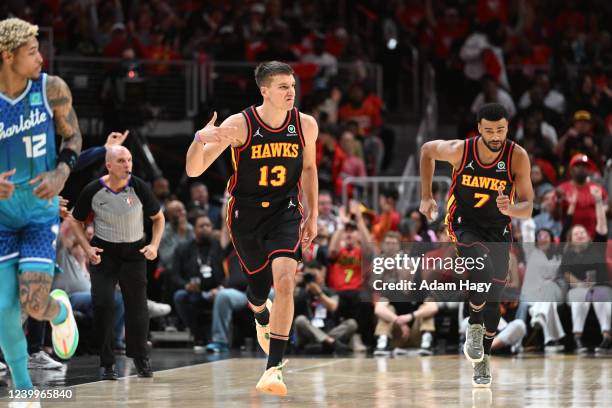 Bogdan Bogdanovic of the Atlanta Hawks celebrates a three point basket against the Charlotte Hornets during the 2022 Play-In Tournament on April 13,...