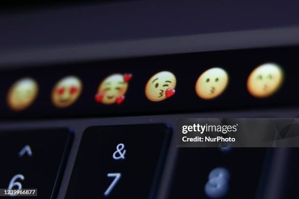 Emojis are seen displayed on MacBook Pro touchbar in this illustration photo taken in Krakow, Poland on April 13, 2022.