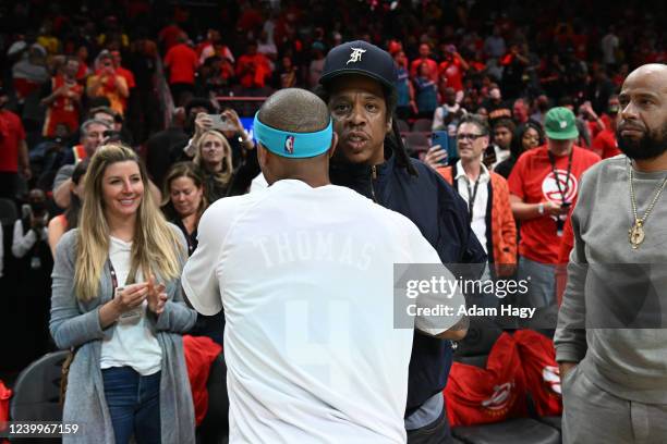 Rapper, Jay-Z embraces and Isaiah Thomas of the Charlotte Hornets embrace after the game against the Atlanta Hawks during the 2022 Play-In Tournament...