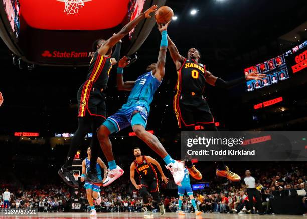 Terry Rozier of the Charlotte Hornets has his shot blocked by Delon Wright of the Atlanta Hawks during the second half at State Farm Arena on April...