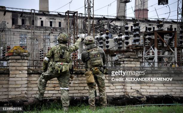 In this picture taken on April 13 Russian soldiers stand guard at the Luhansk power plant in the town of Shchastya. *EDITOR'S NOTE: This picture was...