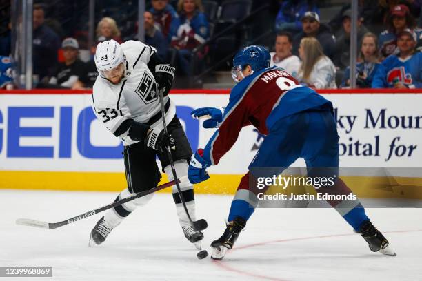 Viktor Arvidsson of the Los Angeles Kings shoots the puck as Cale Makar of the Colorado Avalanche defends during the third period at Ball Arena on...