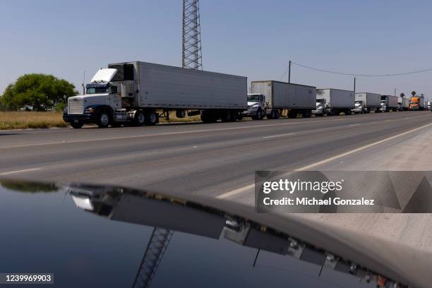 Hundreds of commercial trucks wait in line to cross the Progreso International bridge into Mexico on April 13, 2022 in Progreso, Texas. The bridge...