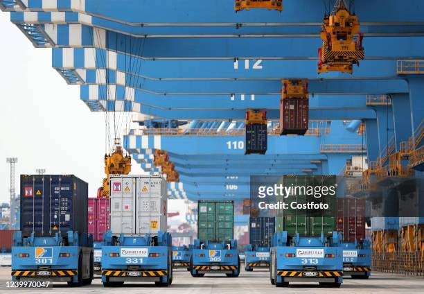 Automatic guided vehicles transport goods at the fully automated wharf of Qingdao Port in East China's Shandong Province, April 13, 2022. The quality...