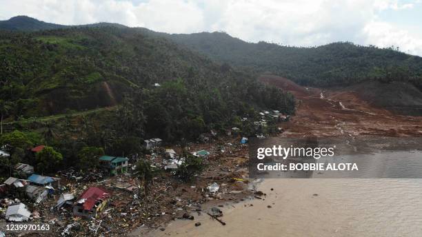 An aerial view shows destroyed houses on a collapsed mountain side along the coastline in the village of Pilar, Abuyog town, Leyte province on April...