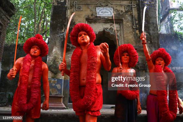 Hindu devotees with their body painted red take part during a a procession in the annual Lal Kach festival in Munshiganj, Bangladesh.As the month of...